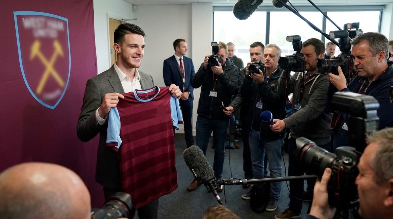 Footballer holding up a club shirt after signing a transfer