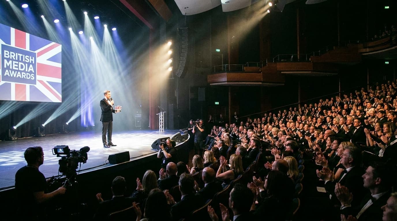 An awards show stage with bright lights and an audience