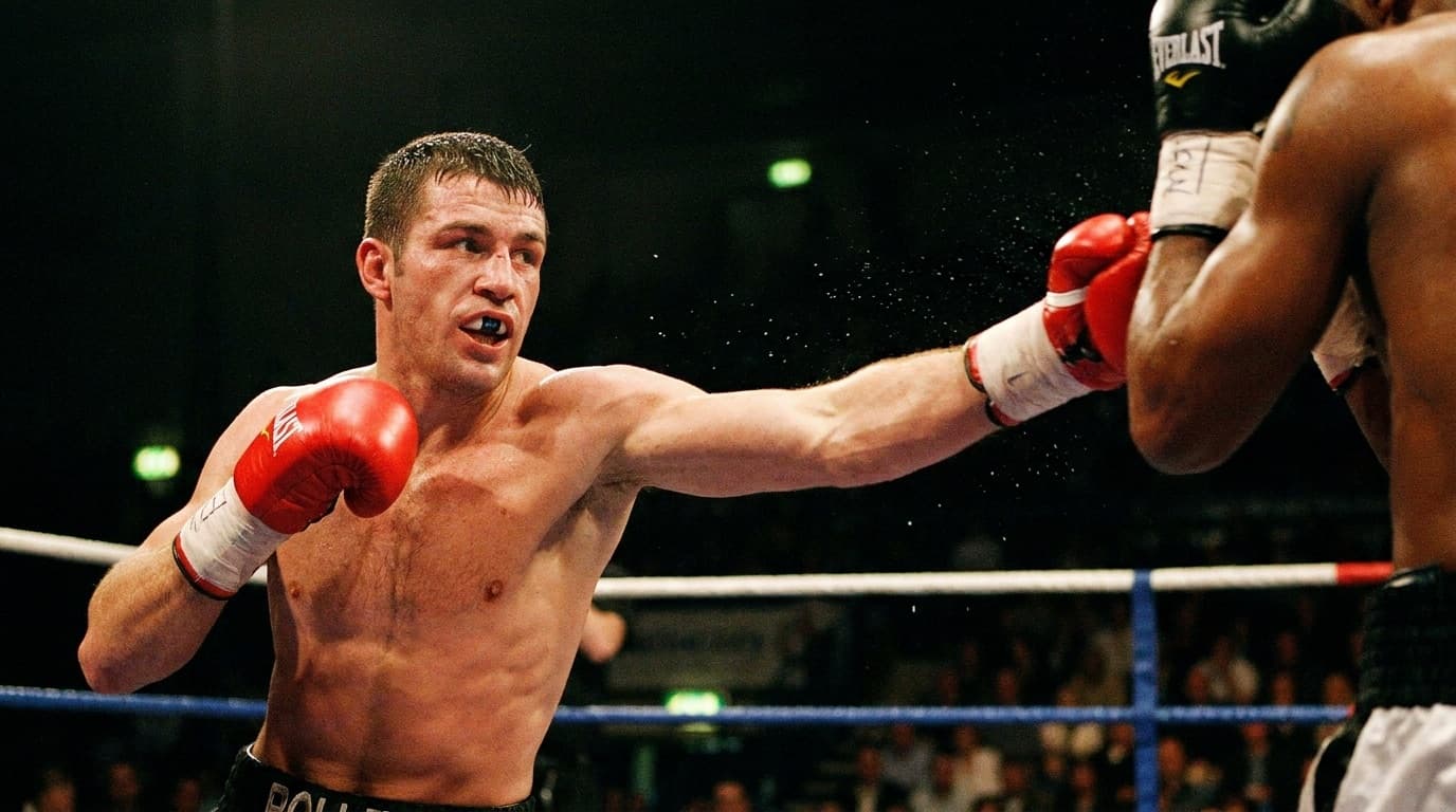 A boxer throwing a punch under the lights of an arena ring