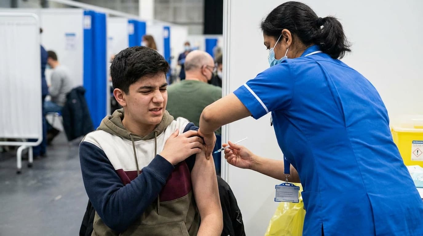 A young person receiving a vaccination in the upper arm at a clinic