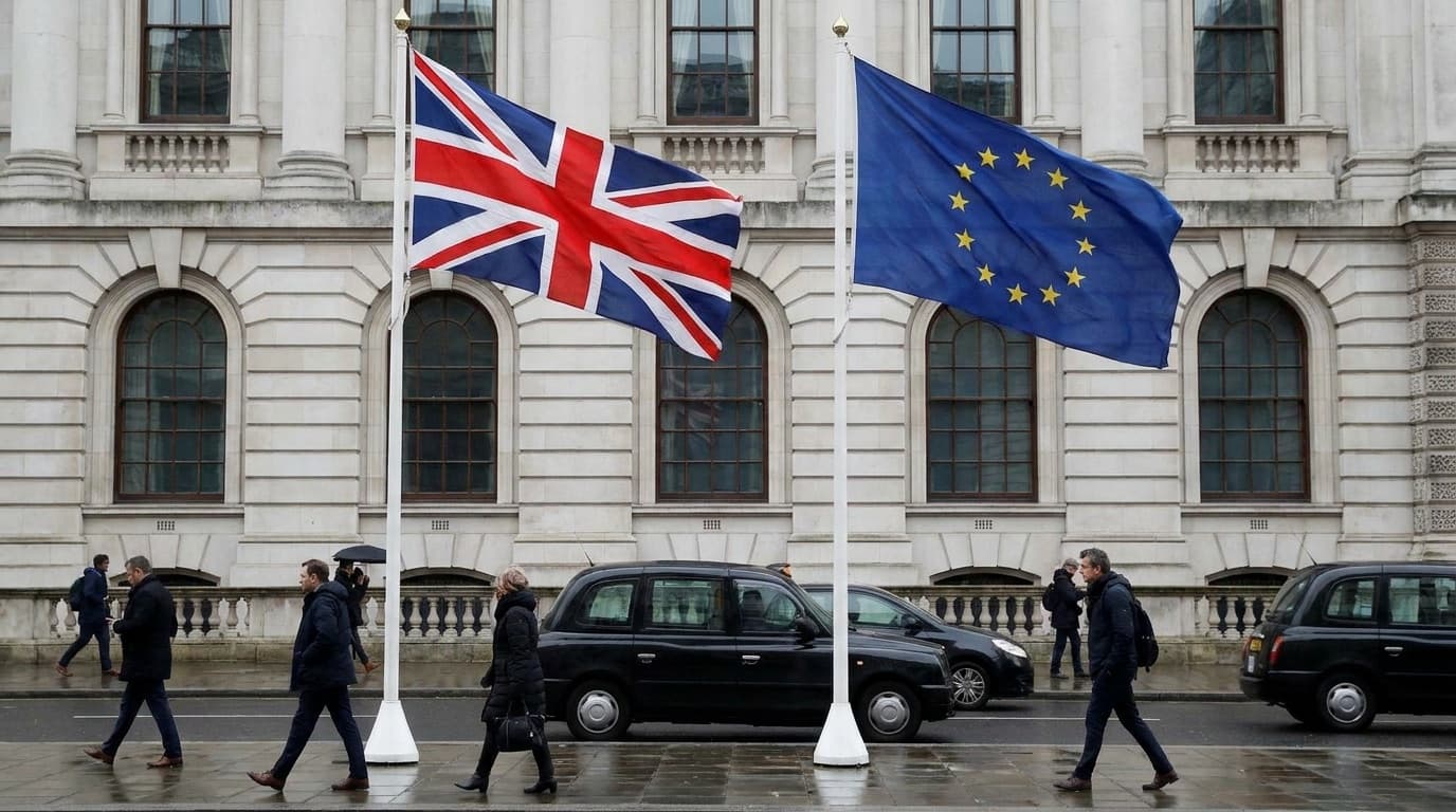 UK and European Union flags flying side by side outside a government building