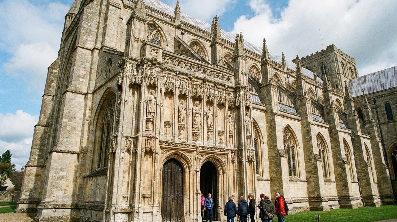 An ornate medieval Gothic monastery with intricate stone carving under a clear sky