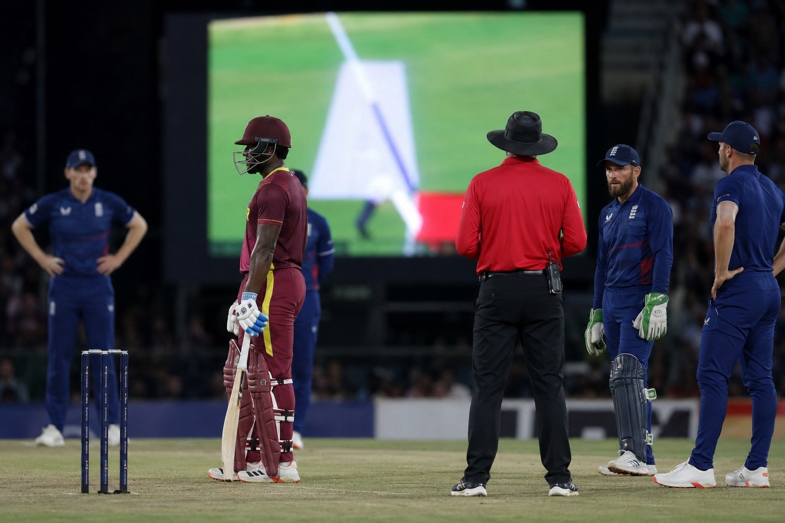 A cricket batter reacting after a disputed umpiring decision